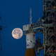 Orion atop SLS, with the target destination glowing in the background.